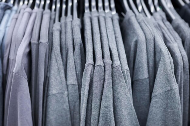 gray sweatshirts on hangers in the store. Gray sweatshirts hang in a fashion store.