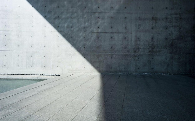 A gray wall with a light on it and a light on the left side