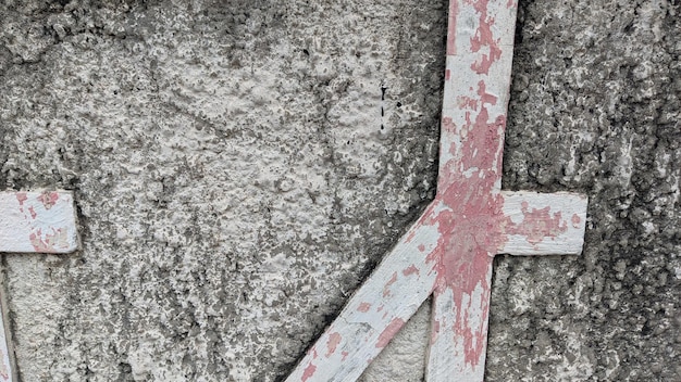 A gray and white wall with a red x on it.