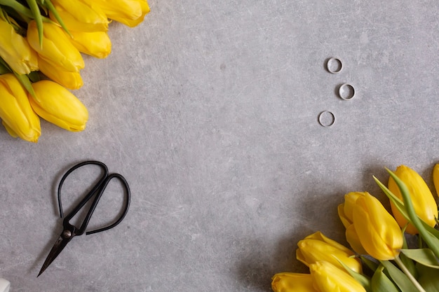 Gray with yellow flowers tulips and scissors table