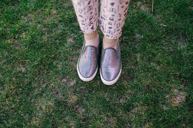 gray women's slippers with sparkles. Slip on feet. shiny shoes