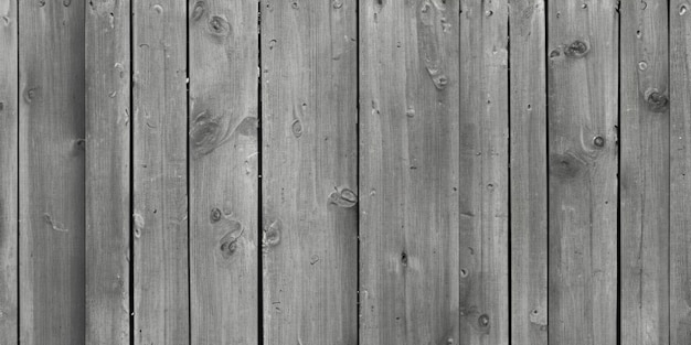 Photo gray wooden fence from an old board burnt in the sun