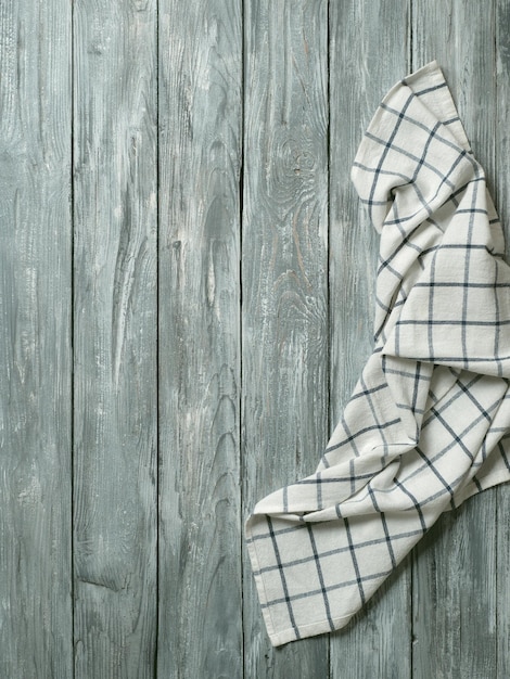 Foto gray wooden table with kitchen napkin flat lay