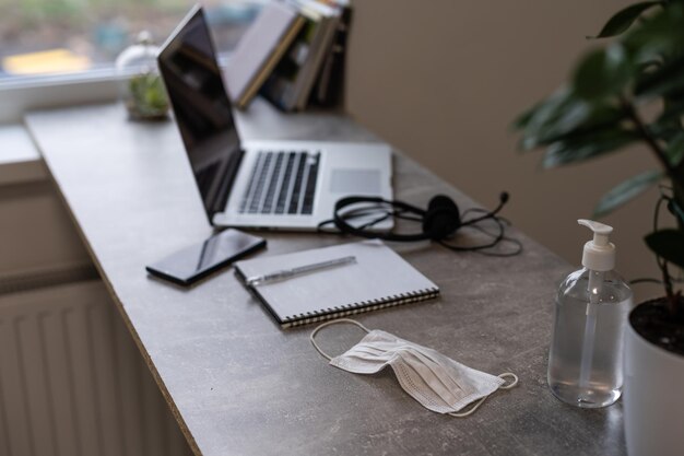 gray workplace with laptop and large window