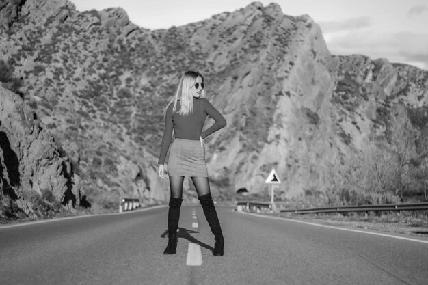 Grayscale portrait of girl in the middle of the road