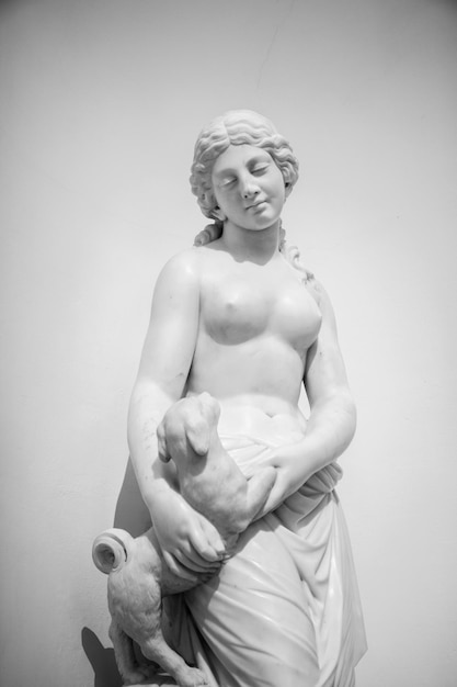 Grayscale shot of a marble statue of a female