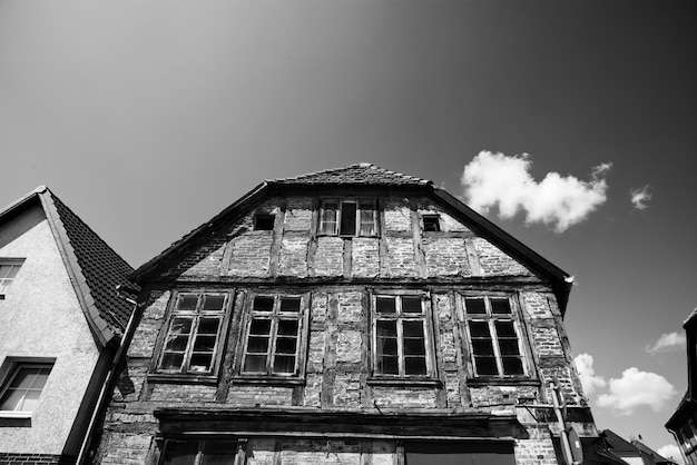 Grayscale shot of the old house facade