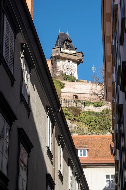 Graz austriamarch 11th 2023 famous schlossberg tower with big cooper bell and clock on the hill overlooking the city of graz austria