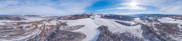 Great aerial mountain panoramic view of the snowy massive rock i