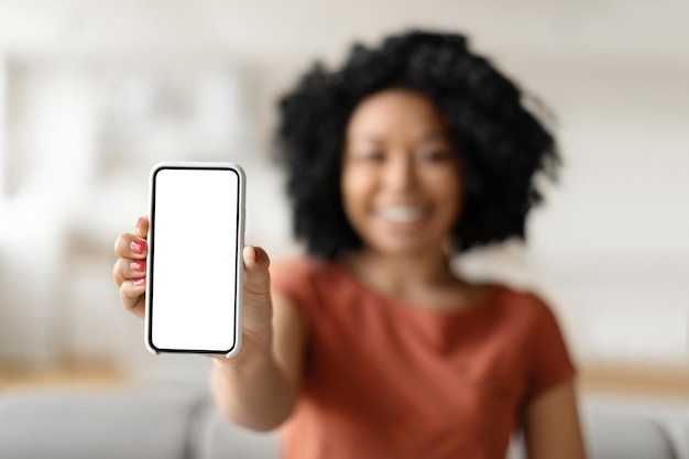 Great app smiling black lady holding smartphone with blank empty screen