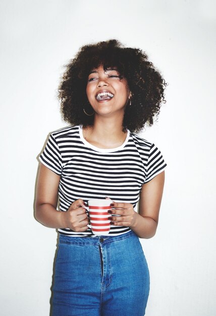 Photo great coffee awesome day studio shot of an attractive young woman enjoying a beverage against a gray background