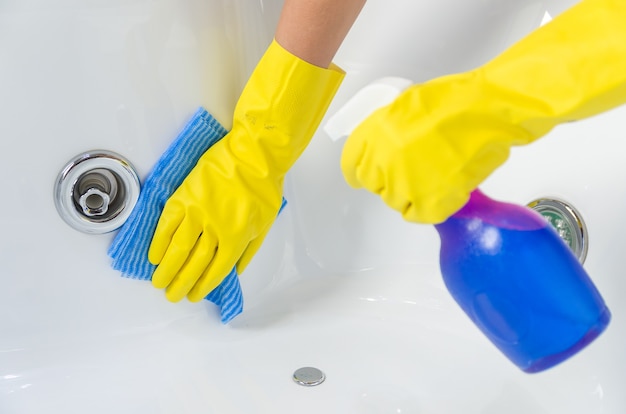 Great concept of domestic cleaning, hand with glove cleaning bath.