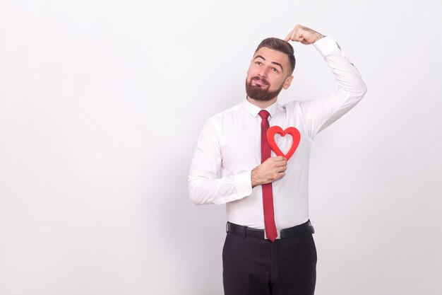 Great idea! Man find his love. Indoor, studio shot, isolated on gray background