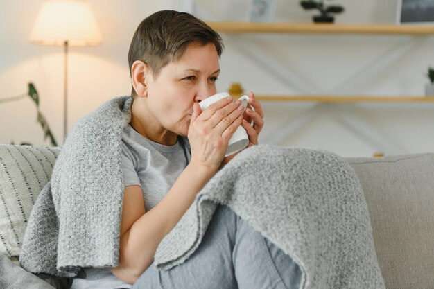 Great looking middle aged woman having a calm morning and enjoying her coffee