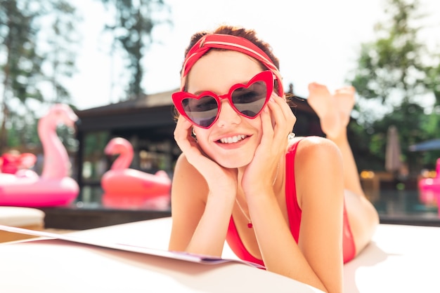 Photo great mood. joyful positive woman smiling while touching her face