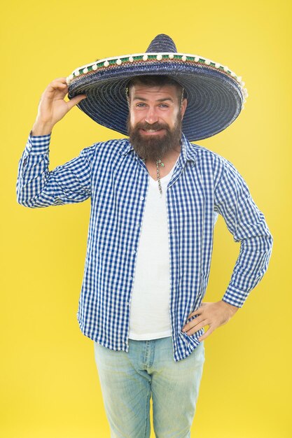 Great party hat traditional fashion accessory for mexican\
costume party bearded man in mexican hat hipster in wide brim hat\
he is in love with mexican style mexican man wearing sombrero