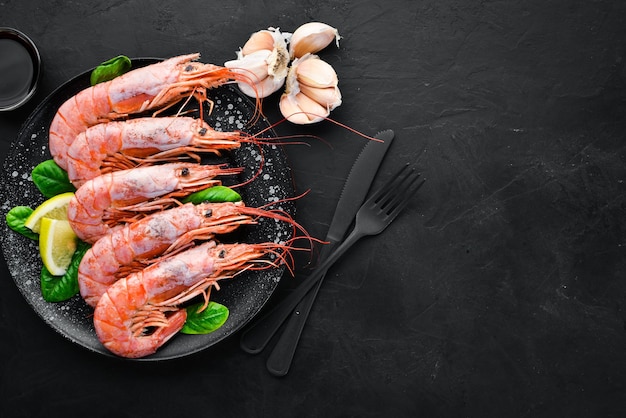 Great Royal Shrimps in a plate Tiger prawns Top view Free space for your text On the old background