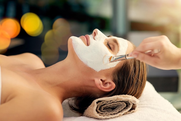 Great skin happens by appointment Shot of a beautiful young woman lying on a massage table at the day spa