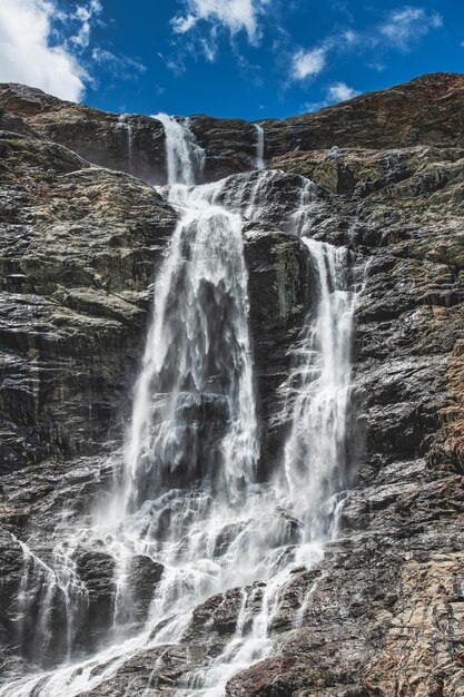 Great waterfall that goes down to the mountains on Swiss alp