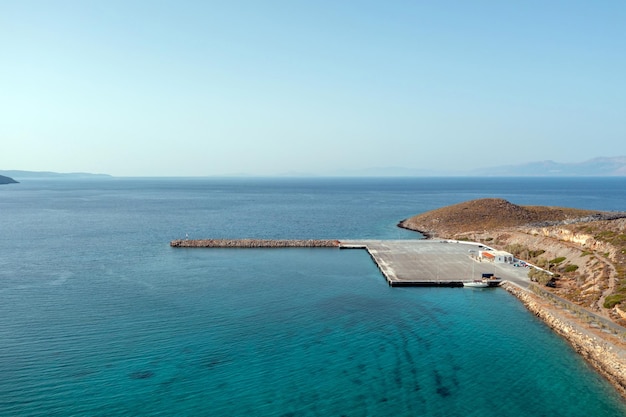 Greece aerial view over kythira island harbor at diakofti blue\
sky and sea sunny summer day