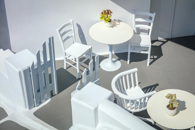 Greece Santorini island Oia Conceptual white architecture top view Tables and chairs Abstract background Greek Islands Santorini