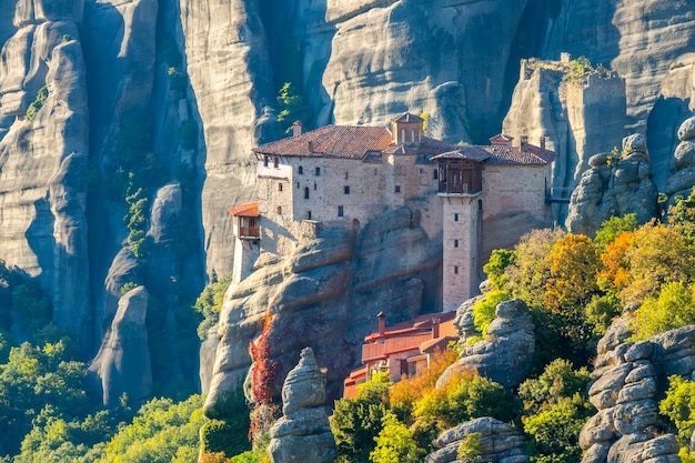 Greece. Sunny summer evening in the mountain valley of Meteora. Stone monastery on top of a cliff