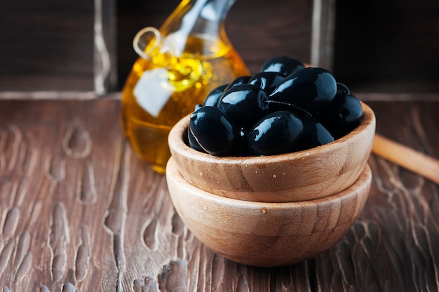 Greek black olive and oil on the wooden table