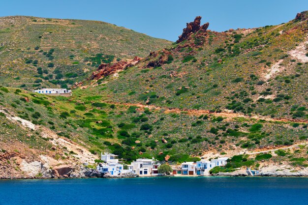 Greek fishing village with traditional whitewashed white houses on Milos island