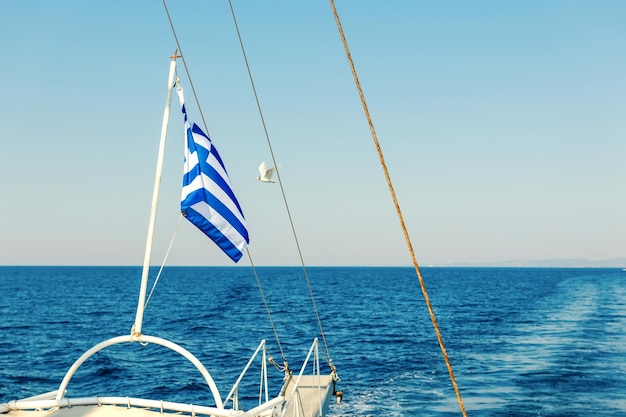 Greek flag waving at the back of a boat