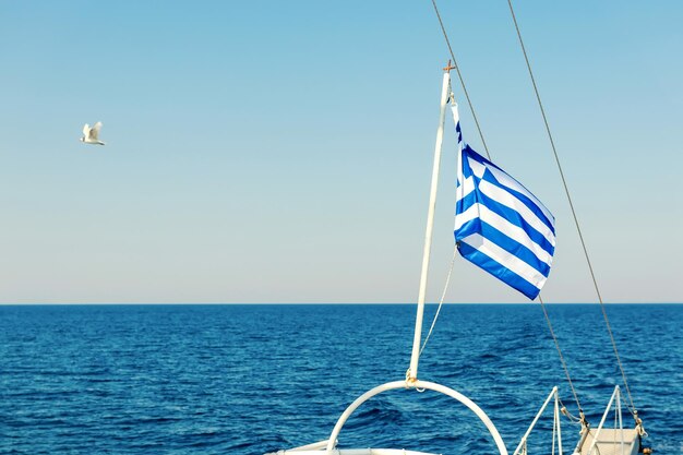 Greek flag waving at the back of a boat