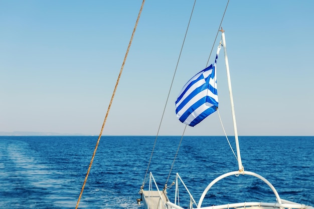 Greek flag waving at the back of a boat