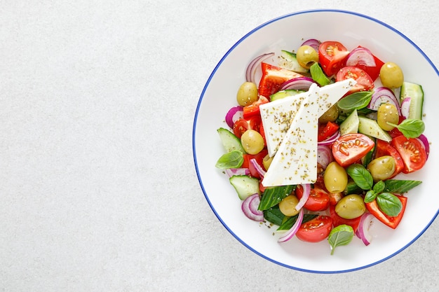 Greek or horiatiki salad with fresh vegetables and feta cheese dressed with olive oil traditional