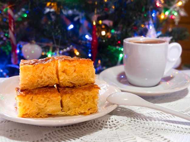 Greek orange pie and coffee on a handmade knitted tablecloth in Greece