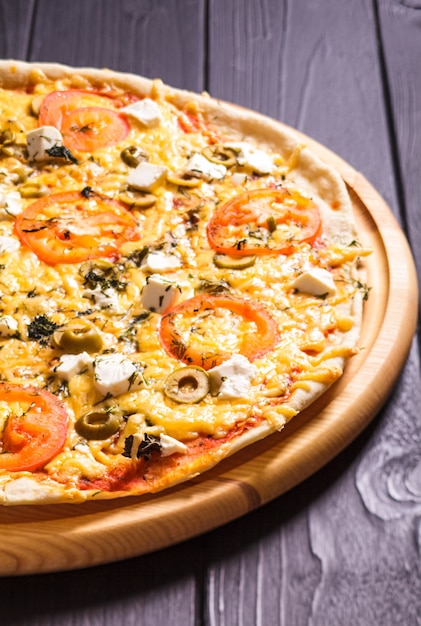 Greek pizza with olives, tomatoes and feta