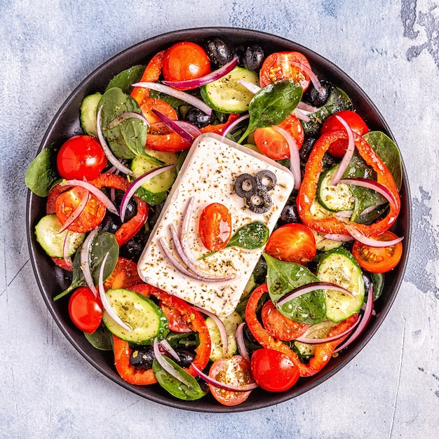 Greek salad on a black plate