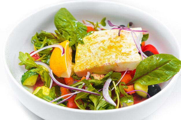 Greek salad in a deep white plate Closeup