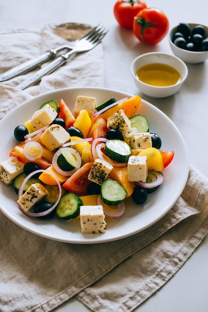 Greek salad of fresh cucumber, tomato, sweet pepper, red onion, feta cheese and olives