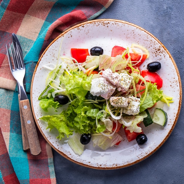 Greek salad on a plate. Top view