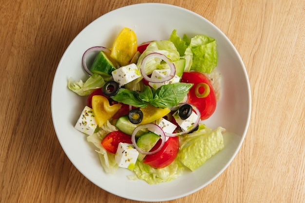 Greek salad in white plate