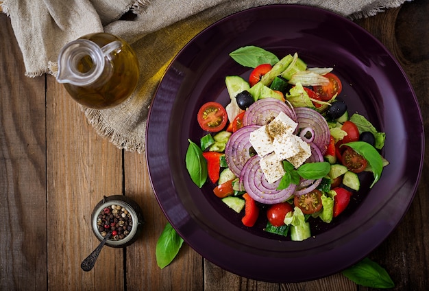 Greek salad with fresh tomato, cucumber, red onion, basil, lettuce, feta cheese, black oli