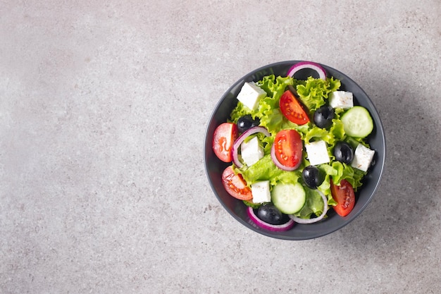 Greek salad with fresh tomatoes cucumber olives feta cheese and red onion