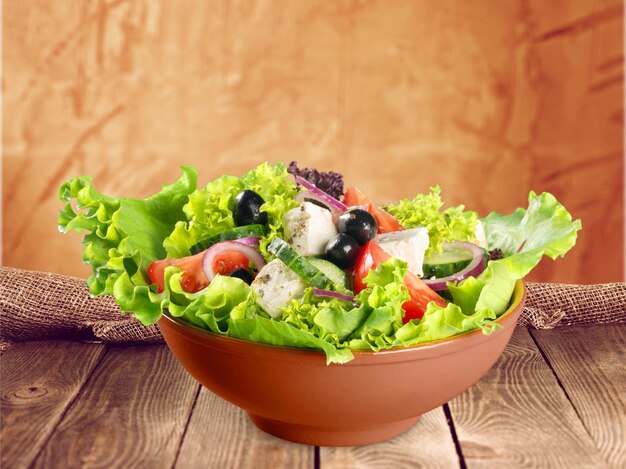 Greek salad with fresh vegetables on background