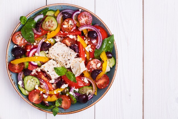 Greek salad with fresh vegetables, feta cheese, black olives