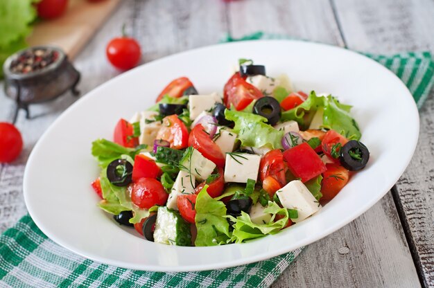 Greek salad with fresh vegetables, feta cheese and black olives