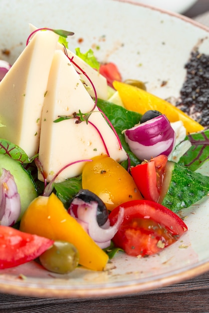 Greek salad with fresh vegetables, feta cheese close up