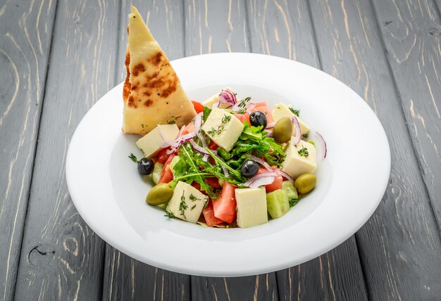 Greek salad with hard cheese and olives