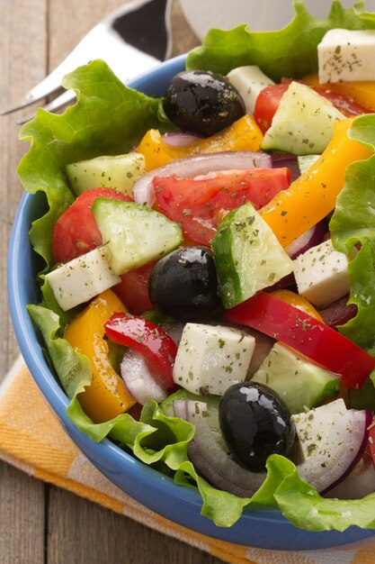 Greek salad on wood background