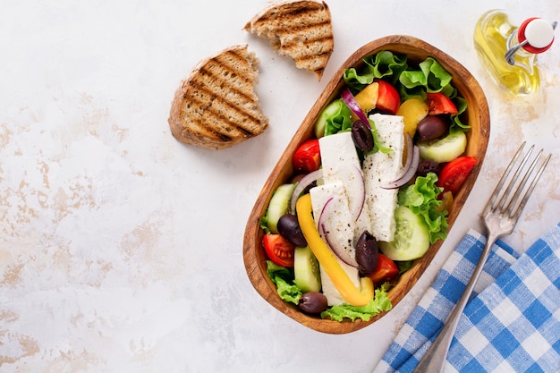 Greek salad in wooden plate