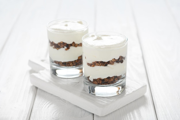 Greek yogurt with granola in glass jar Parfait