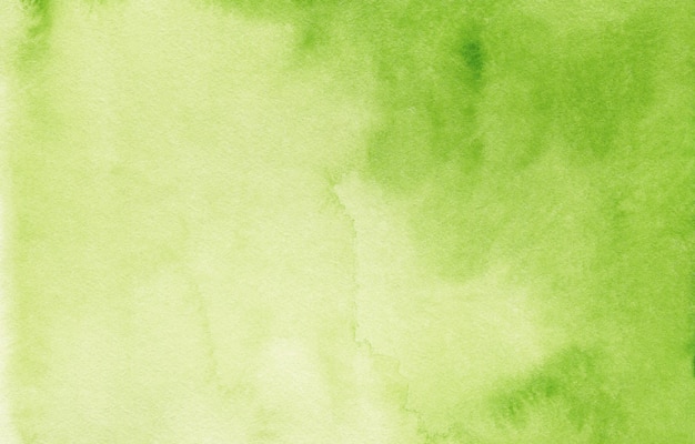 Green abstract watercolor background on textured paper